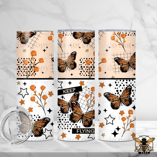 Three tumblers with butterfly designs on a white background