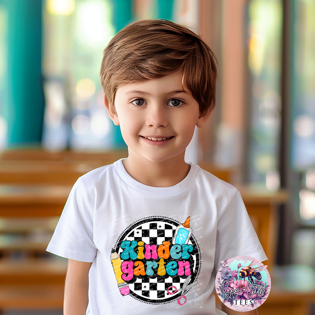 Child wearing a white t-shirt with 'Kinder garden' design in a classroom setting