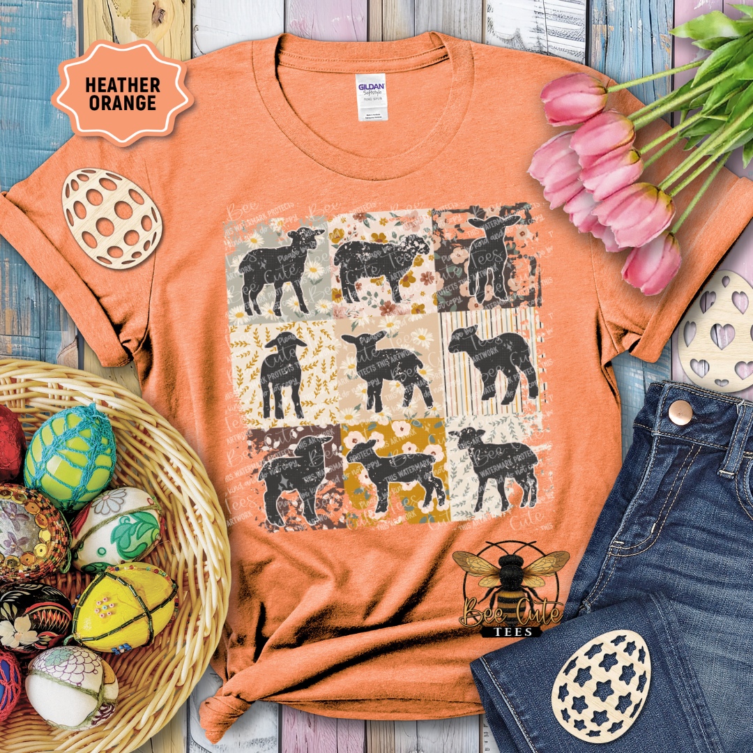 Orange t-shirt with black dog pattern, surrounded by tulips and decorative items on a wooden surface.