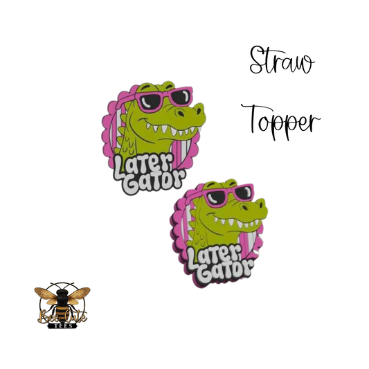 Two green gator-shaped straw toppers with pink sunglasses and 'Later Gator' text on a white background.
