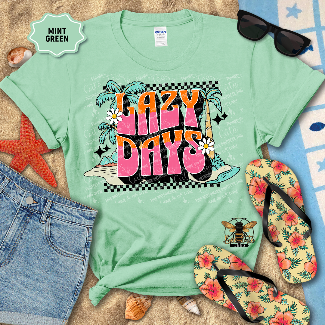 Mint green t-shirt with 'Lazy Days' design on a beach-themed background with sunglasses, flip-flops, and starfish.