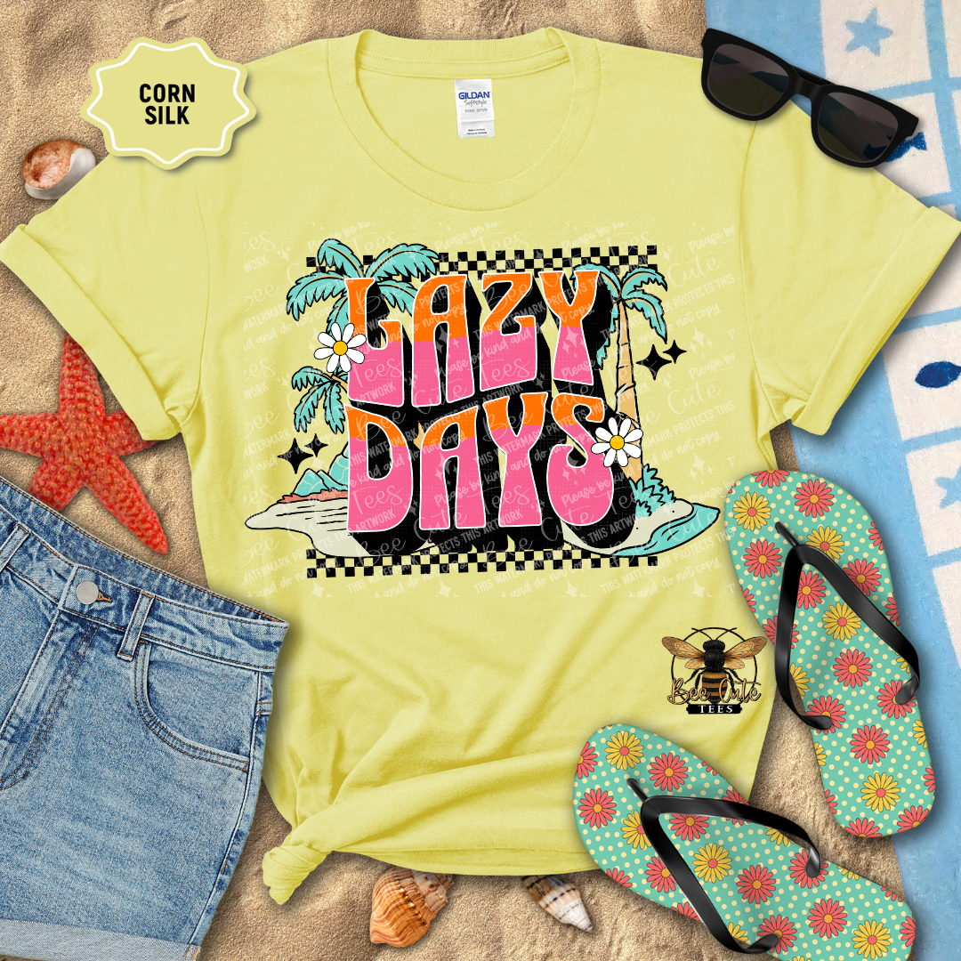 Yellow t-shirt with 'Lazy Days' design on a beach setting with sunglasses, flip-flops, and denim shorts.