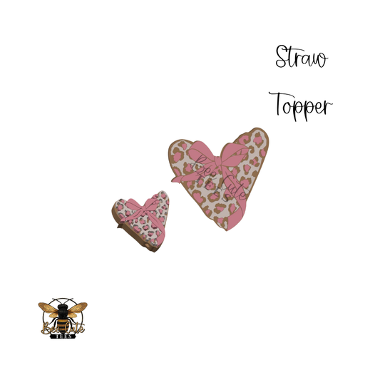 Heart-shaped straw toppers with pink and brown patterns on a white background