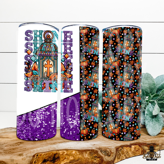 Three slim tumbler cups displayed upright on a wooden slice with a green succulent in the background. The tumblers feature a Fall-themed design with purple glitter sections, orange pumpkins, teal lanterns, and decorative text on a white and black background.