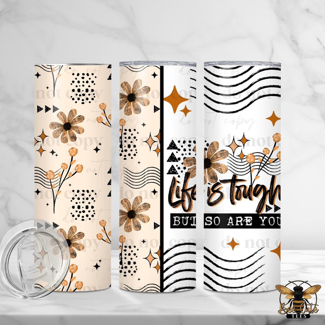 Three tumblers with floral and geometric designs on a white background