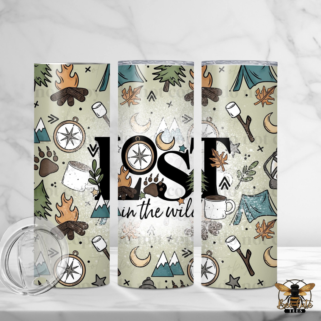 Three insulated tumblers with a rustic outdoor camping pattern are displayed on a white marble surface. The pattern features illustrations of campfires, tents, mountains, stars, and the words 'Join the wild' in black script.