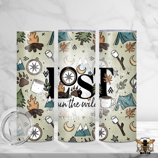 Three insulated tumblers with a rustic outdoor camping pattern are displayed on a white marble surface. The pattern features illustrations of campfires, tents, mountains, stars, and the words 'Join the wild' in black script.