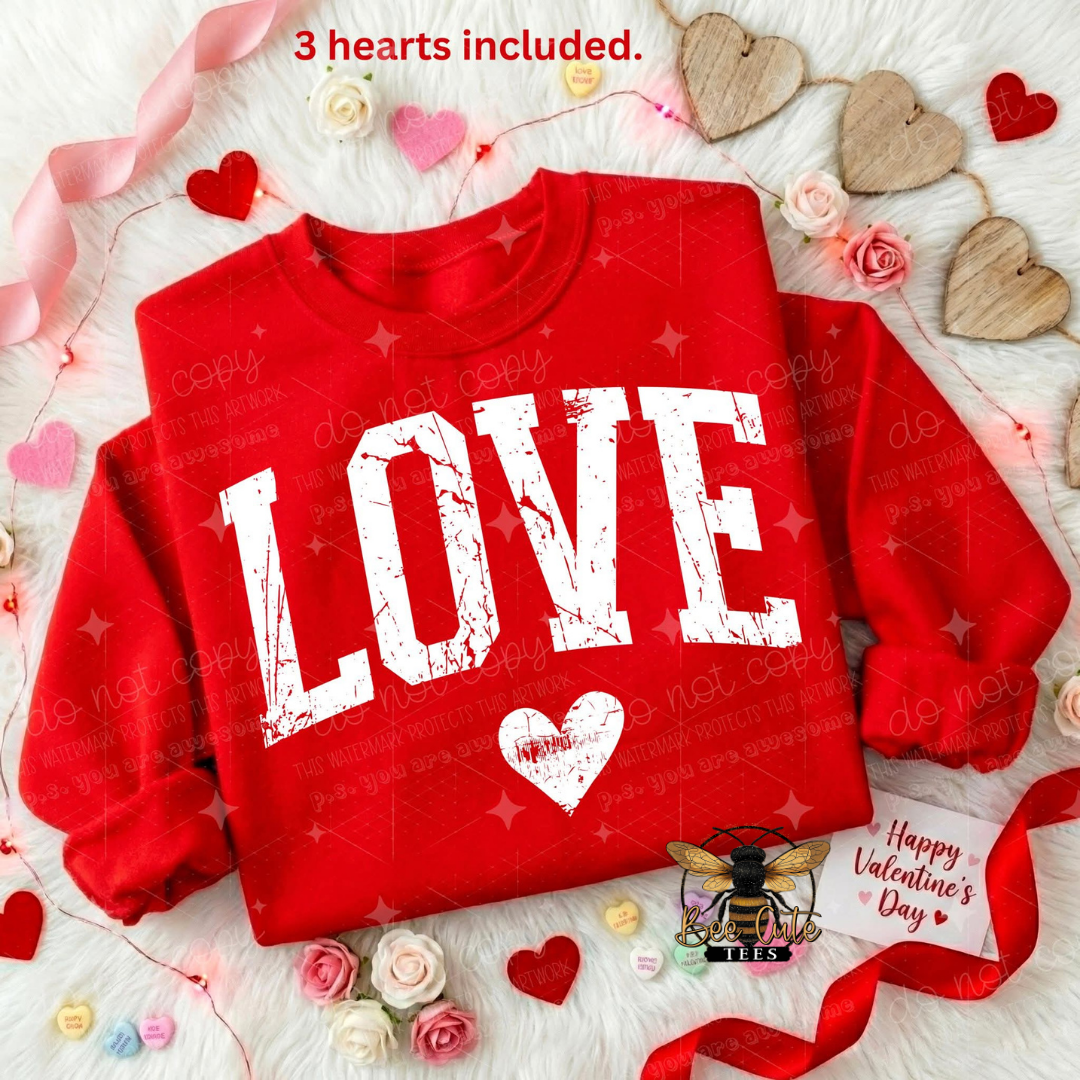 Red sweatshirt with 'LOVE' printed on it, surrounded by heart decorations and flowers.