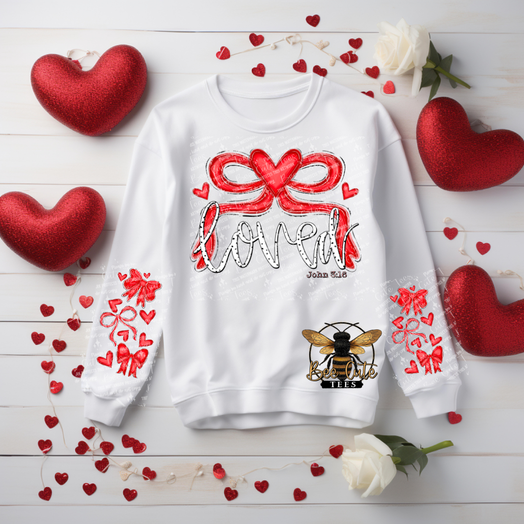 White sweatshirt with red heart design and text on a wooden surface with heart decorations