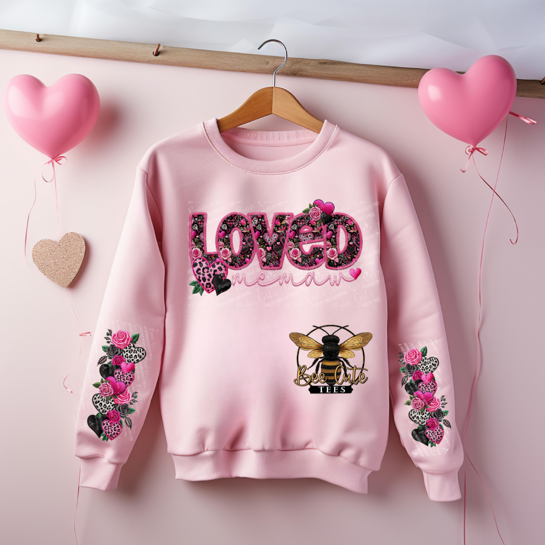 Pink sweatshirt with floral designs and text on a pink background with balloons