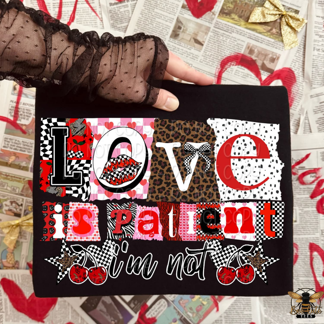 Black pouch with 'Love is patient, I'm not' text and patterned design held by a gloved hand on a newspaper background.