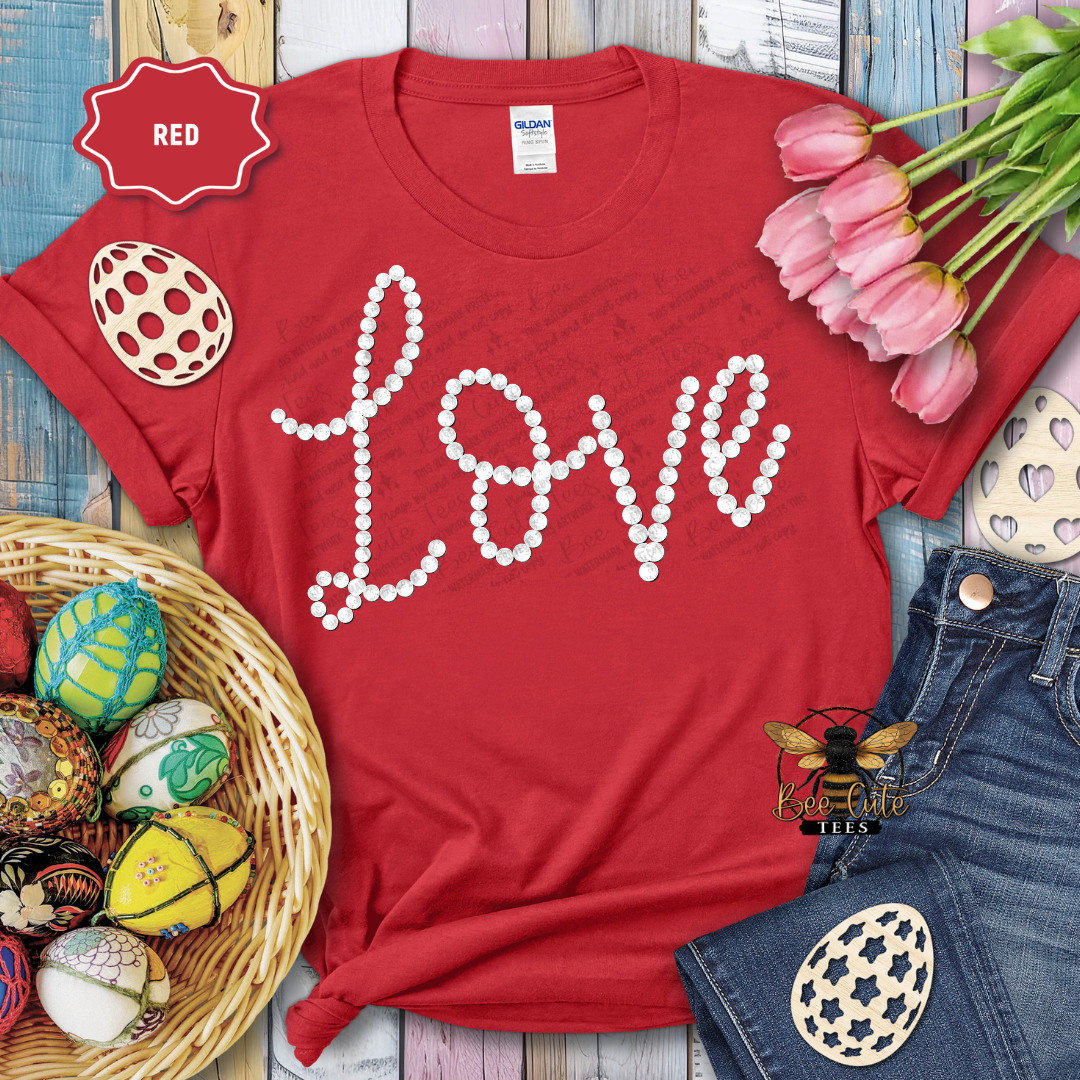 Red t-shirt with 'LOVE' text, Easter eggs, and tulips on a wooden surface