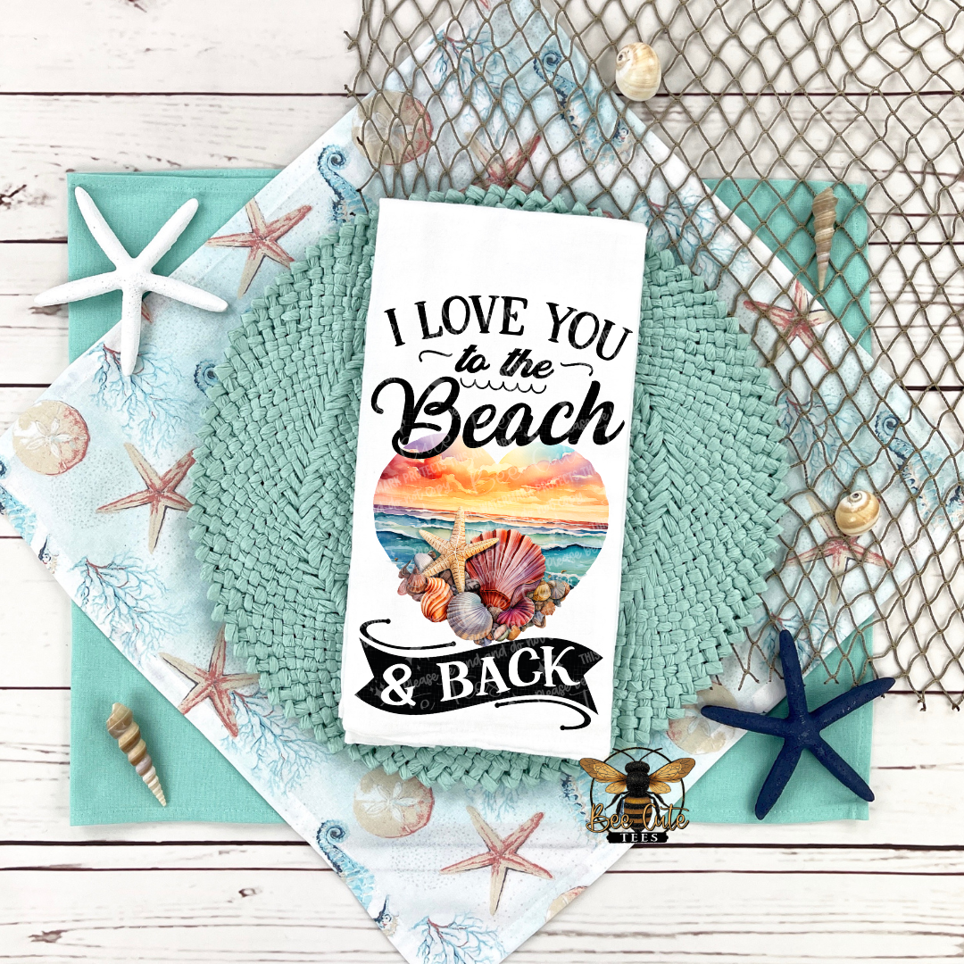 Decorative towel with 'I Love You to the Beach & Back' text and beach-themed design on a textured surface.
