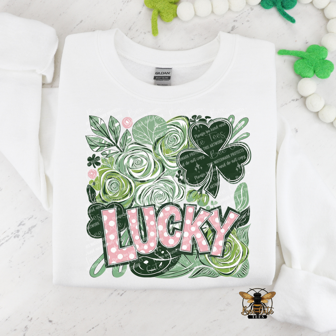 White sweatshirt with green floral design and 'LUCKY' text on a white background