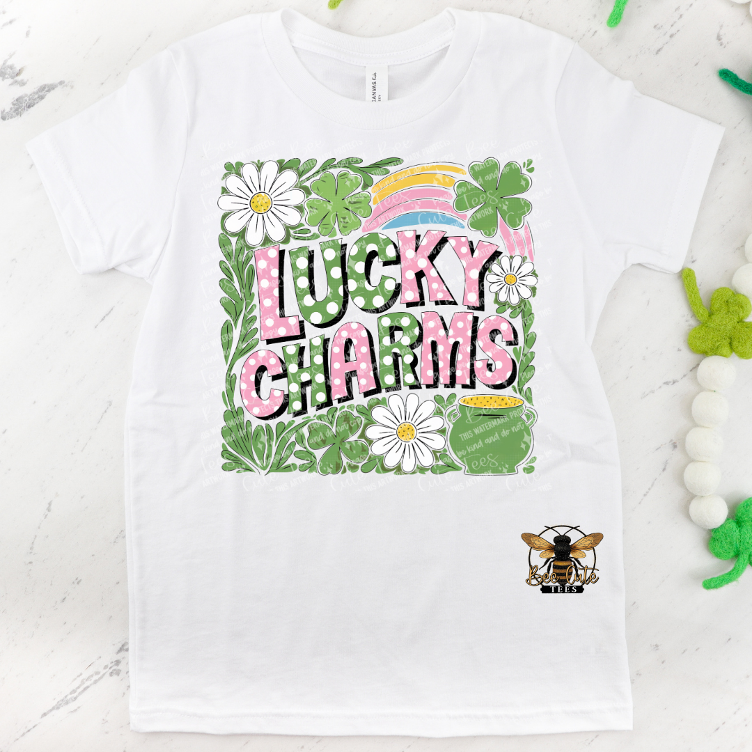 White t-shirt with 'Lucky Charms' design featuring flowers and a rainbow on a white background.