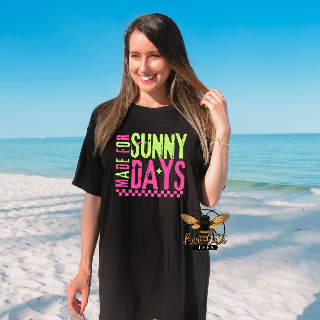 Woman wearing a black t-shirt with colorful text on a beach