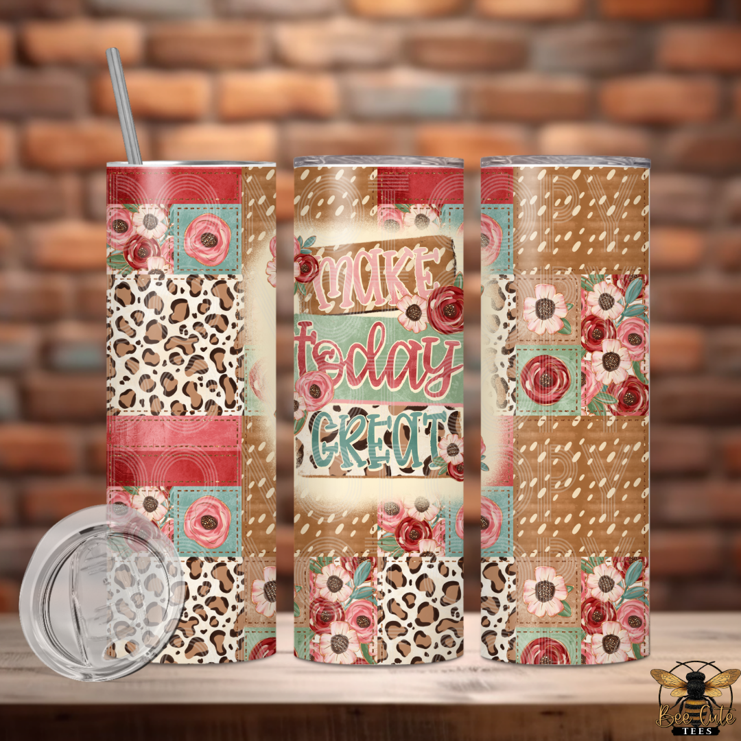 Colorful tumbler with patterned design and text on a wooden surface with brick wall background