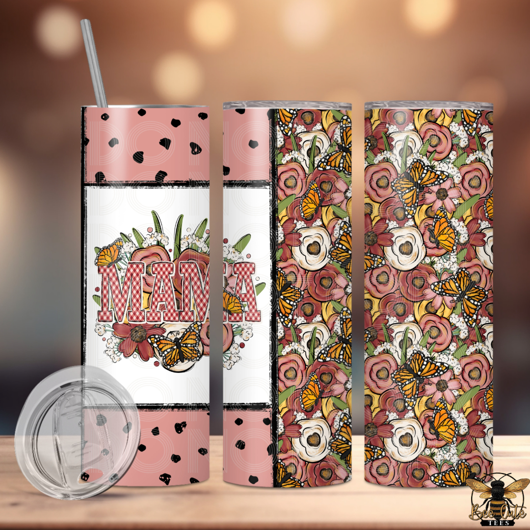 Set of three floral-themed tumblers with decorative patterns on a wooden surface.