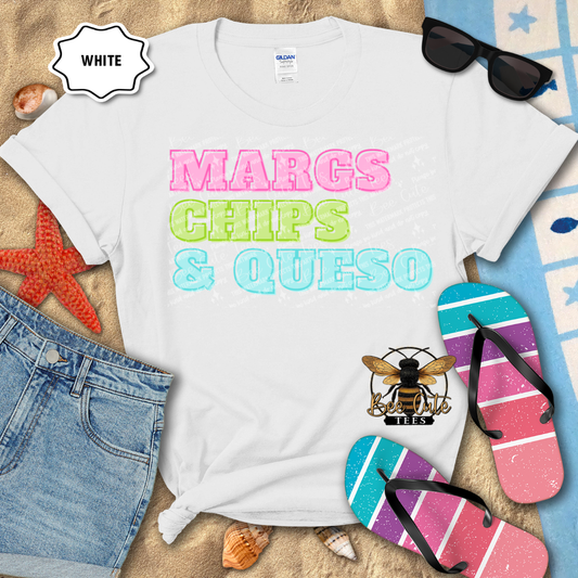 White t-shirt with 'MARGS CHIPS & QUESO' text, sunglasses, and flip-flops on a beach-themed background.