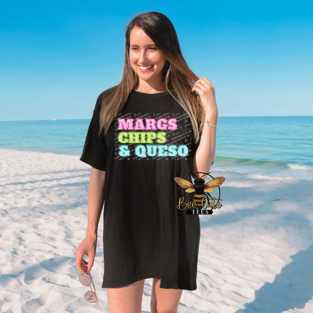 Woman wearing a black t-shirt with colorful text on a beach