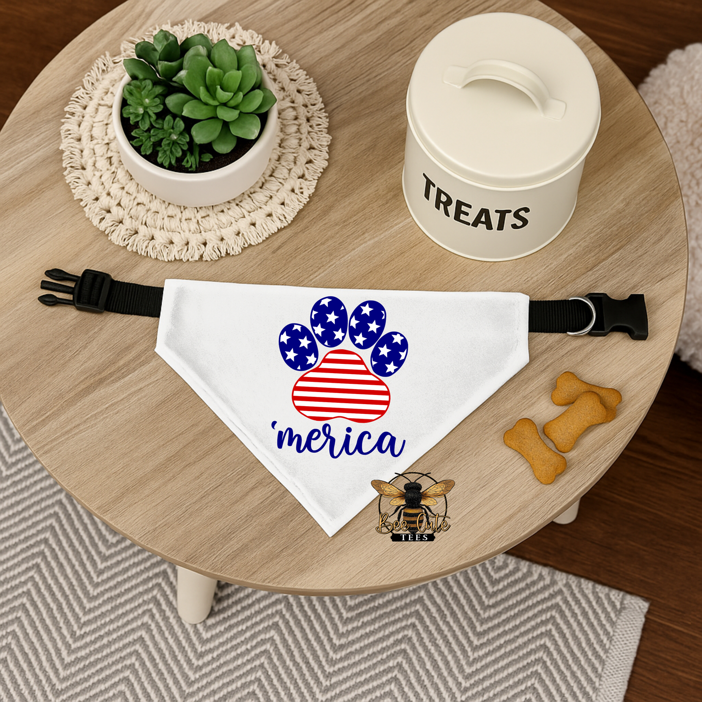 Dog bandana with 'merica design on a wooden table with treats and a plant.