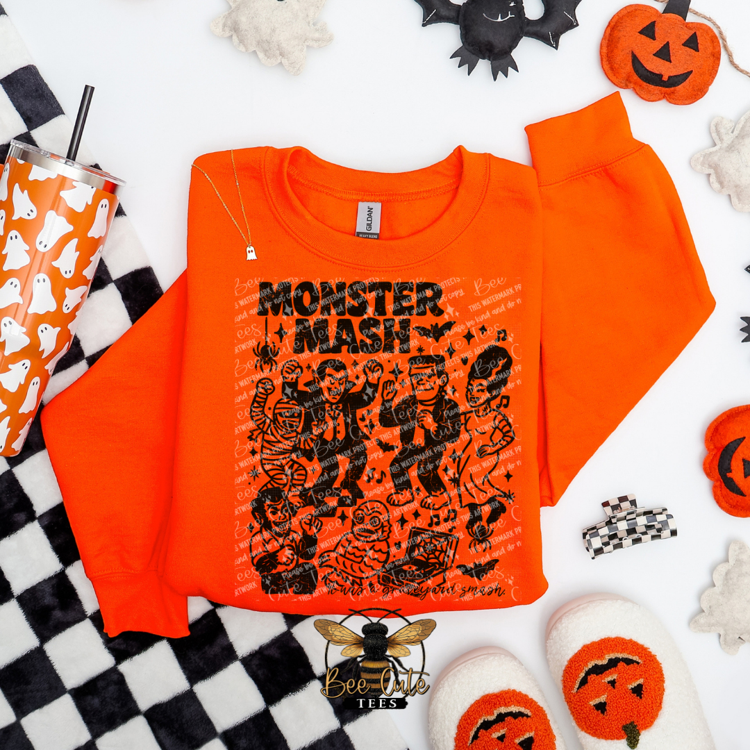 Orange sweatshirt with 'Monster Mash' design on a Halloween-themed background