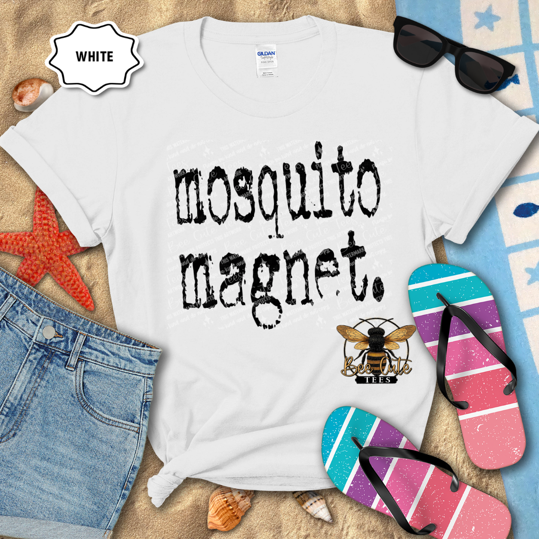 White t-shirt with 'mosquito magnet' text and bee logo on a beach-themed background