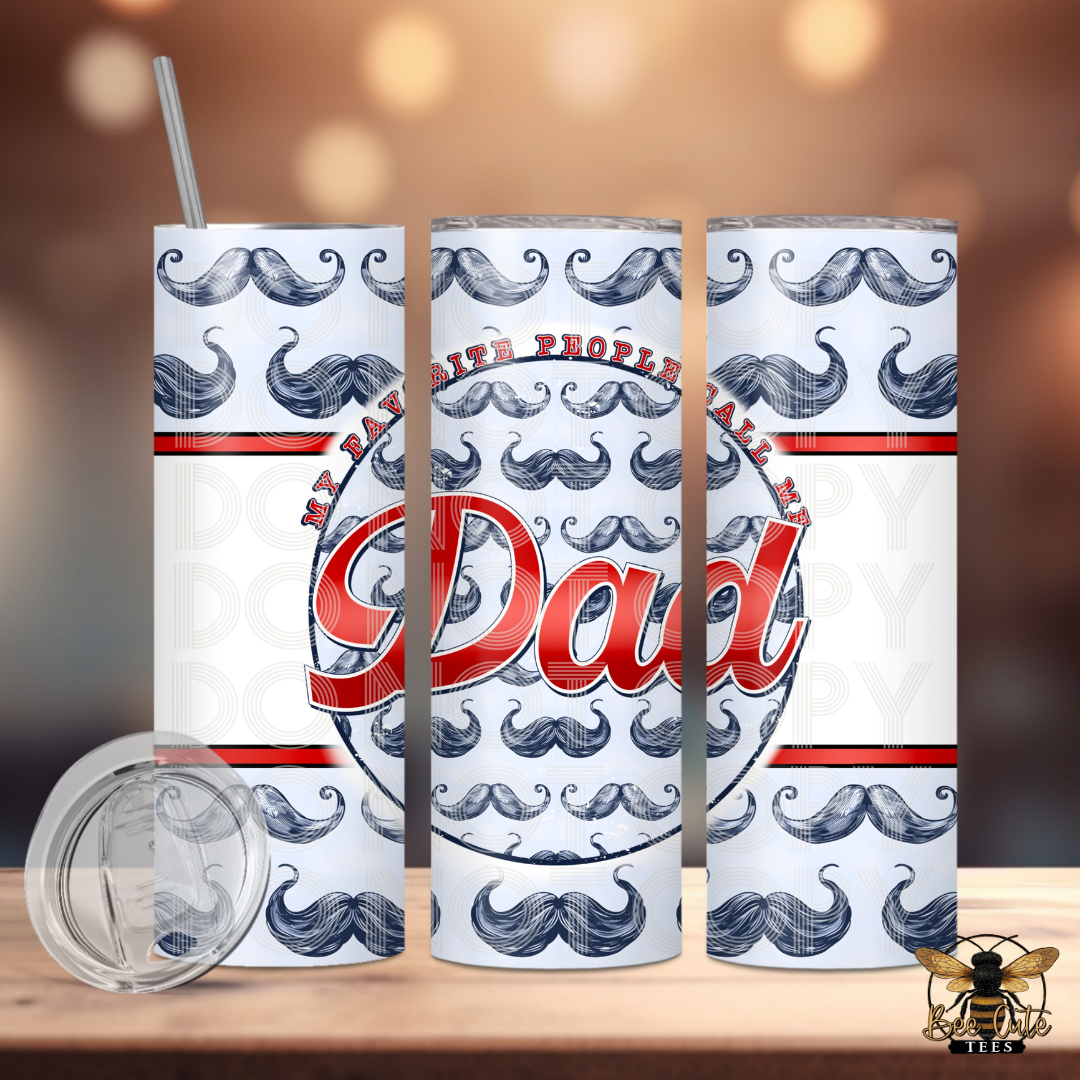 Tumbler with mustache pattern and 'Dad' text on a wooden surface with a blurred background
