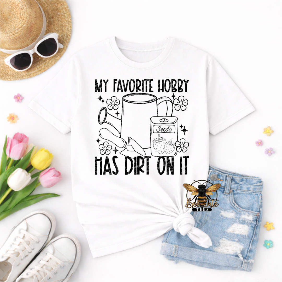 White t-shirt with gardening-themed design and accessories on a white background