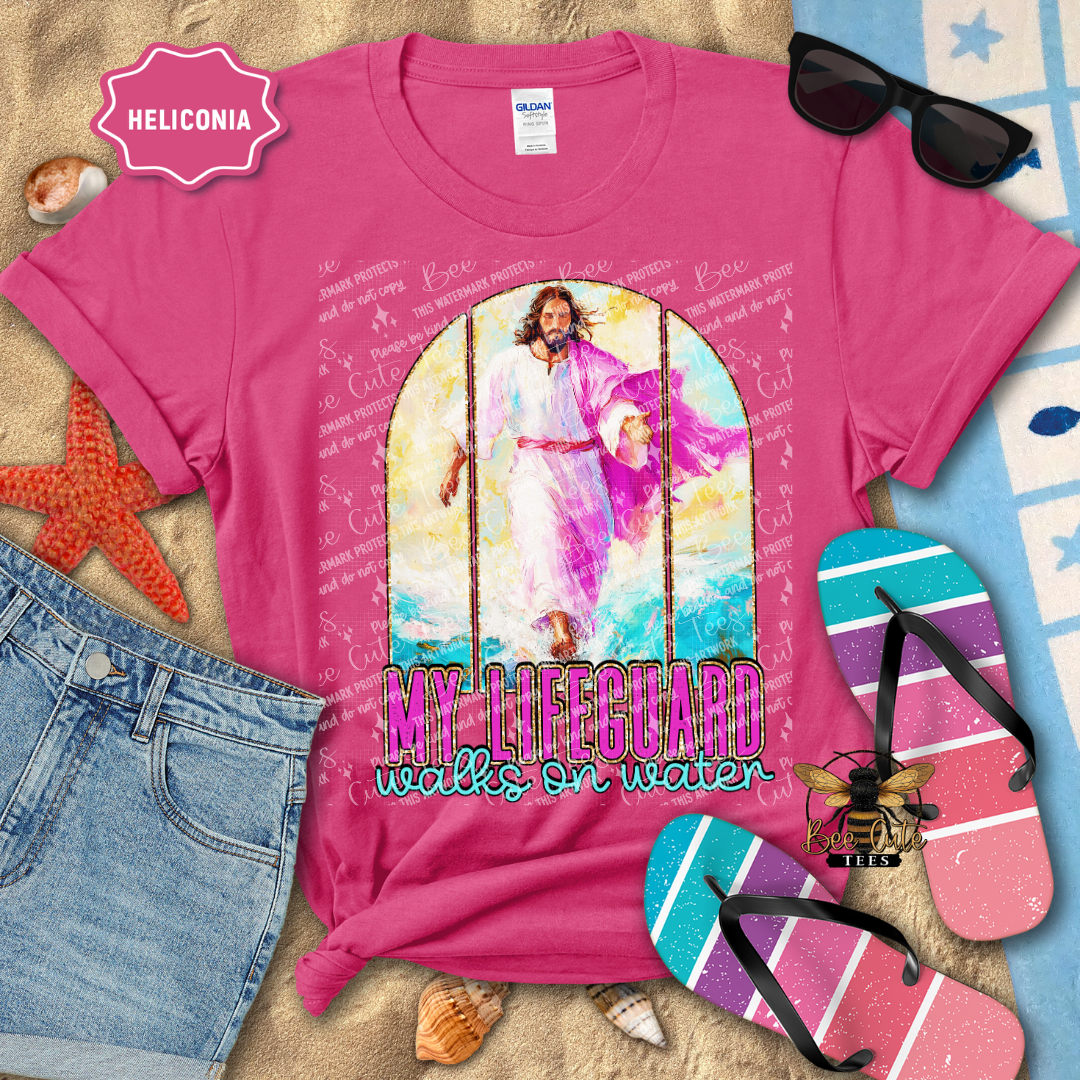 Pink t-shirt with religious design and text, sunglasses, and flip-flops on a beach-themed background.