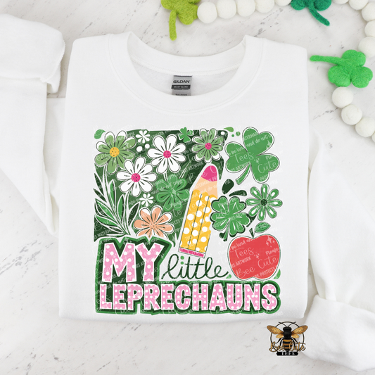 White sweatshirt with a colorful design featuring flowers, a pencil, and text on a white background.