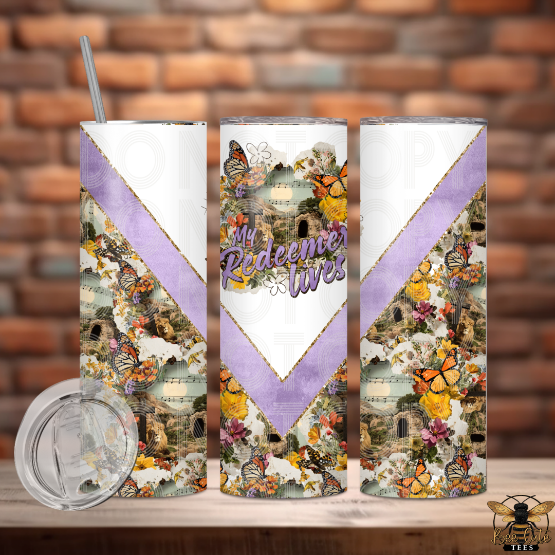 Tumbler with butterfly design and 'My Redeemer Lives' text on a wooden surface with brick wall background