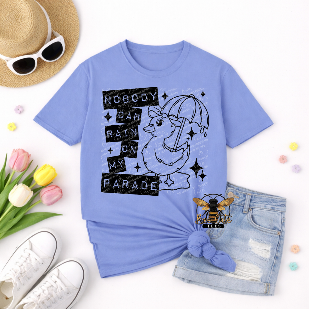 Light blue t-shirt with graphic design and accessories on a white background