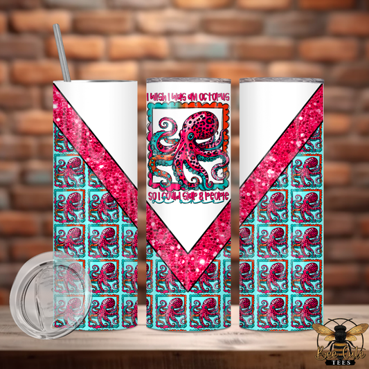 Tumbler with pink octopus design and text on a wooden surface with brick wall background