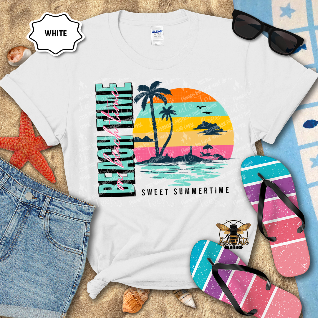 White t-shirt with a colorful beach-themed design, sunglasses, flip-flops, and denim shorts on a sandy background.