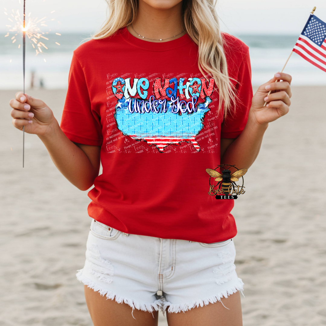 Person wearing a red t-shirt with a patriotic design on a beach.