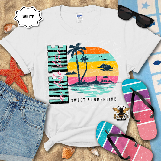 White t-shirt with a colorful 'Sweet Summertime' design, sunglasses, flip-flops, and denim shorts on a sandy background.