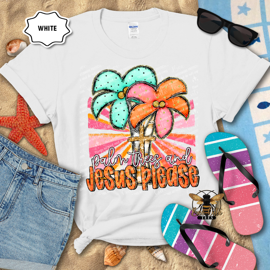 White t-shirt with colorful palm tree design and text 'Palm Trees and Jesus Please' on a beach-themed background.