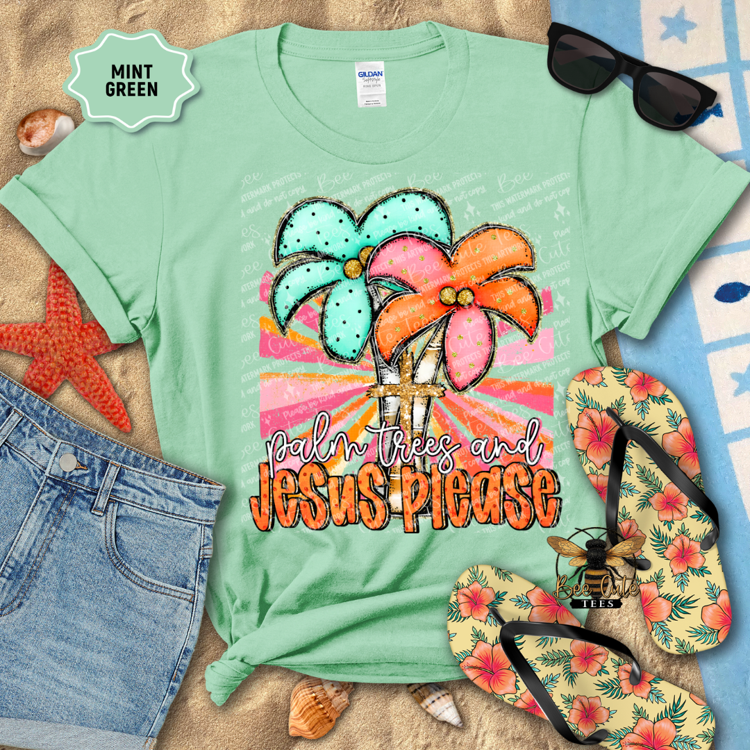 Mint green t-shirt with palm tree and 'Palm Trees and Jesus Please' text, surrounded by beach accessories.