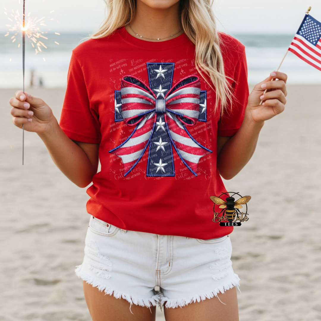 Person wearing a red t-shirt with a patriotic design on a beach