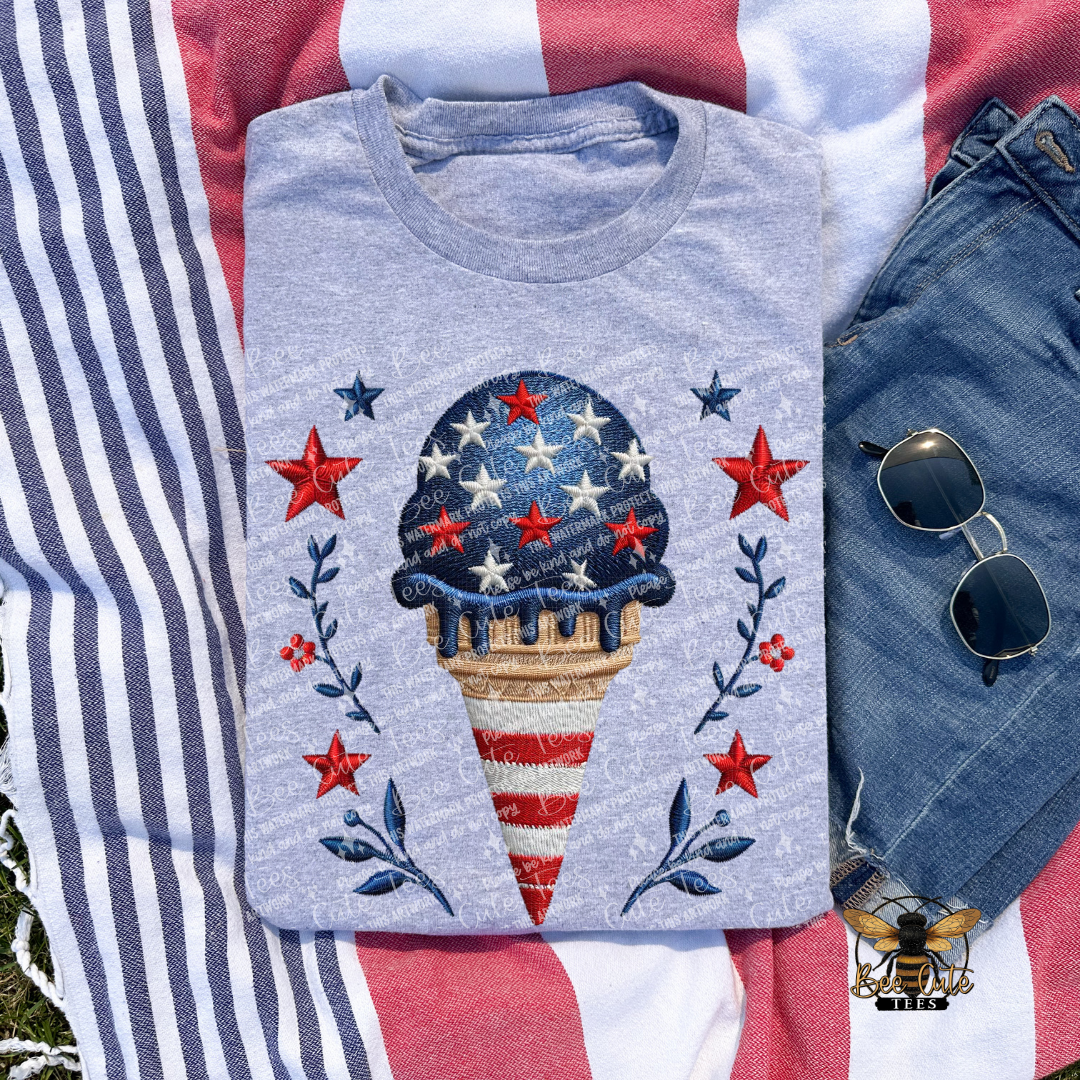 Gray t-shirt with ice cream cone design on a red, white, and blue striped background