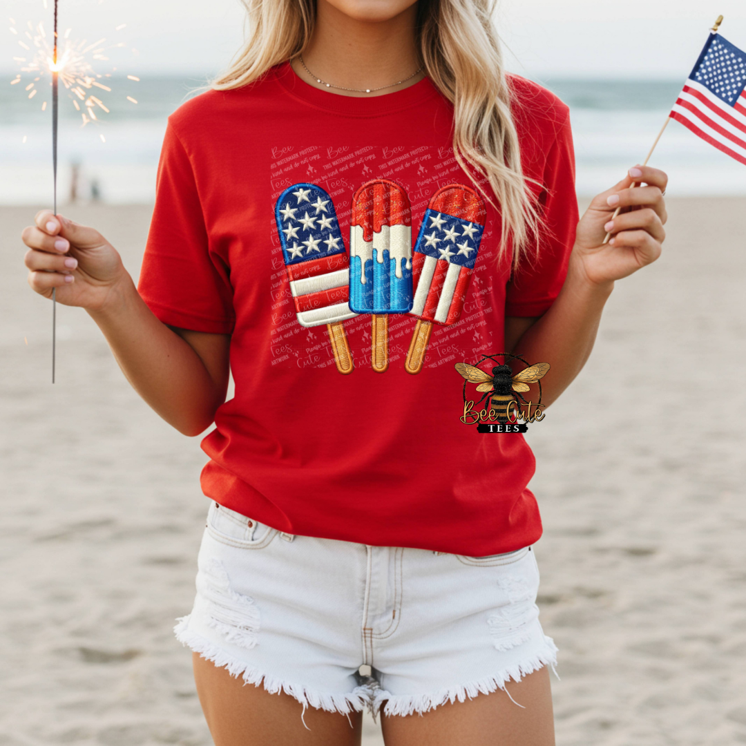 Person wearing a red t-shirt with patriotic design on a beach