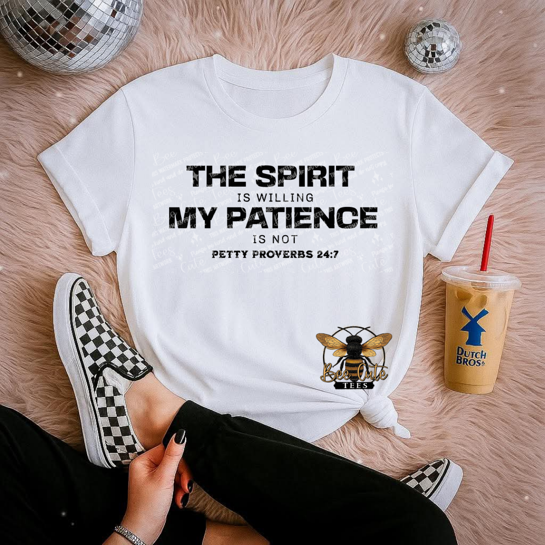 White t-shirt with motivational quote, checkered shoes, and iced coffee on a wooden floor.