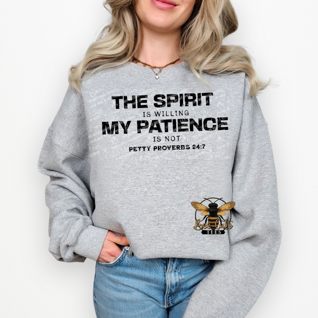 Person wearing a gray sweatshirt with a motivational quote and bee logo on a white background