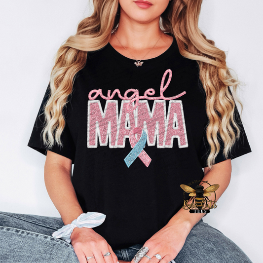 Person wearing a black t-shirt with 'angel mama' text and pink and blue ribbon design.