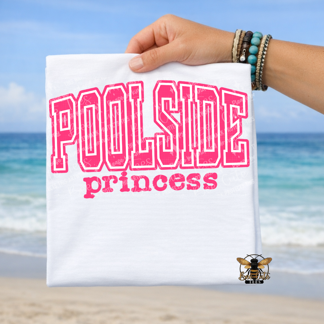Hand holding a t-shirt with 'Poolside princess' text against a beach background