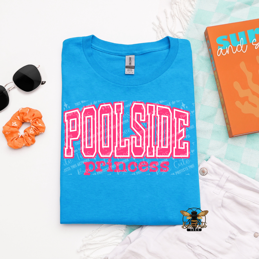 Blue t-shirt with 'Poolside Princess' text on a light blue background with accessories.