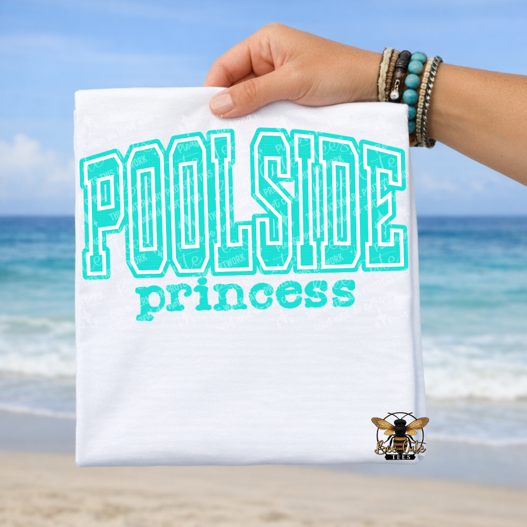 Hand holding a white t-shirt with 'Poolside princess' text against a beach background
