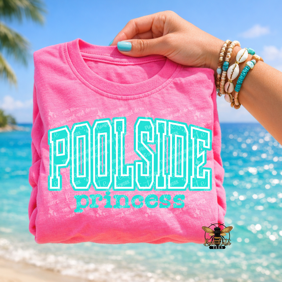 Pink t-shirt with 'Poolside princess' text held by a hand against a beach background