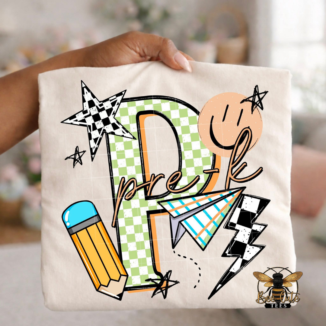 Folded white-colored unisex T-shirt held up by a hand, featuring a colorful "Pre K" graphic. The design includes green checkered number four, bold black lettering, peach script, a pencil, paper airplane, smiley face, lightning bolt, stars, and playful doodles. A fun, retro-inspired back-to-school design perfect for fourth grade teachers and students.
